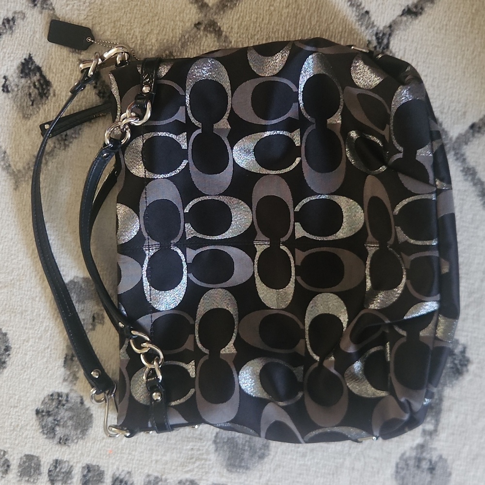 Medium/Large black and silver coach bag.